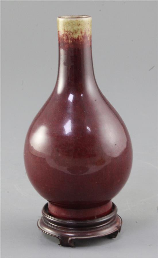 A Chinese Langyao sang de boeuf glazed bottle vase, 18th century, height 15cm. wood stand